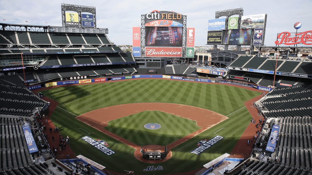 Members of the media and grounds crew work on the field at Citi Field in New York, Thursday, Oct. 29, 2015. The New York Mets are to face the Kansas City Royals in Game 3 of the World Series at the stadium on Friday. (AP Photo/Peter Morgan)