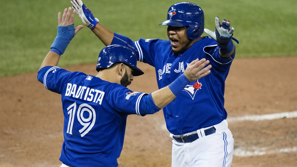 Toronto Blue Jays' Jose Bautista, left, and Edwin Encarnacion celebrate scoring on a three-RBI double by Troy Tulowitzki during the sixth inning in Game 5 of baseball's American League Championship Series on Wednesday, Oct. 21, 2015, in Toronto. (Darren Calabrese/The Canadian Press via AP) MANDATORY CREDIT