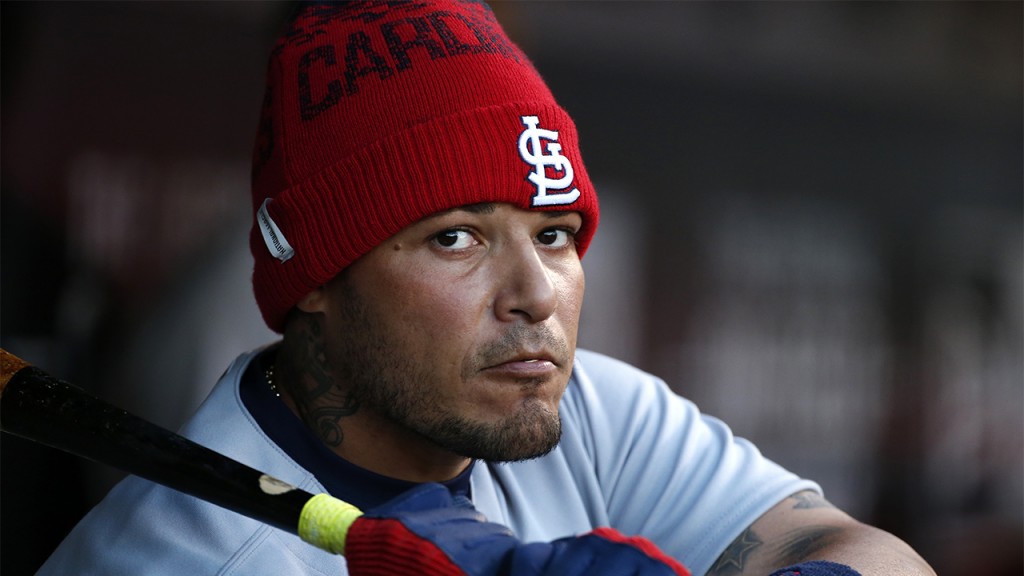 St. Louis Cardinals catcher Yadier Molina warms up in the dugout during the first inning of a baseball game against the Pittsburgh Pirates in Pittsburgh, Tuesday, April 5, 2016. (AP Photo/Gene J. Puskar)