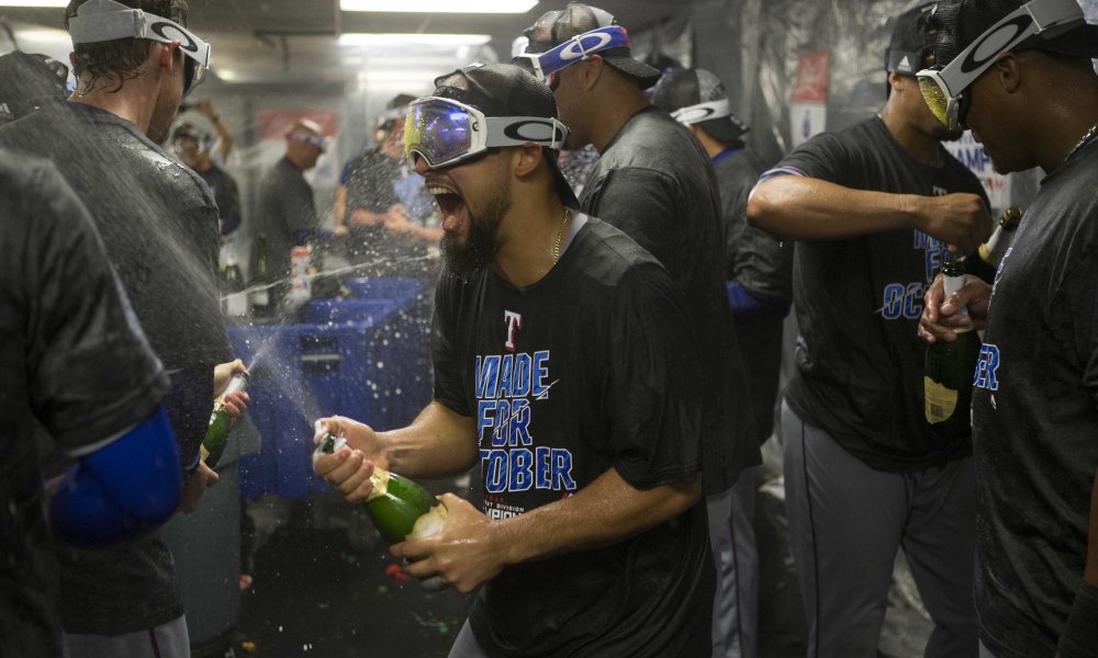 Sep 23, 2016; Oakland, CA, USA; Texas Rangers players celebrate in their locker room after clinching the AL West at Oakland Coliseum. The Rangers won 3-0. Mandatory Credit: Neville E. Guard-USA TODAY Sports ORG XMIT: USATSI-262854 ORIG FILE ID:  20160923_ads_gb7_376.JPG