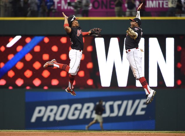 Cleveland Indians shortstop Francisco Lindor, left, and center fielder Rajai Davis celebrate their 2-1 win against the Toronto Blue Jays in Game 2 of baseball's American League Championship Series in Cleveland, Saturday, Oct. 15, 2016. (Nathan Denette/The Canadian Press via AP)