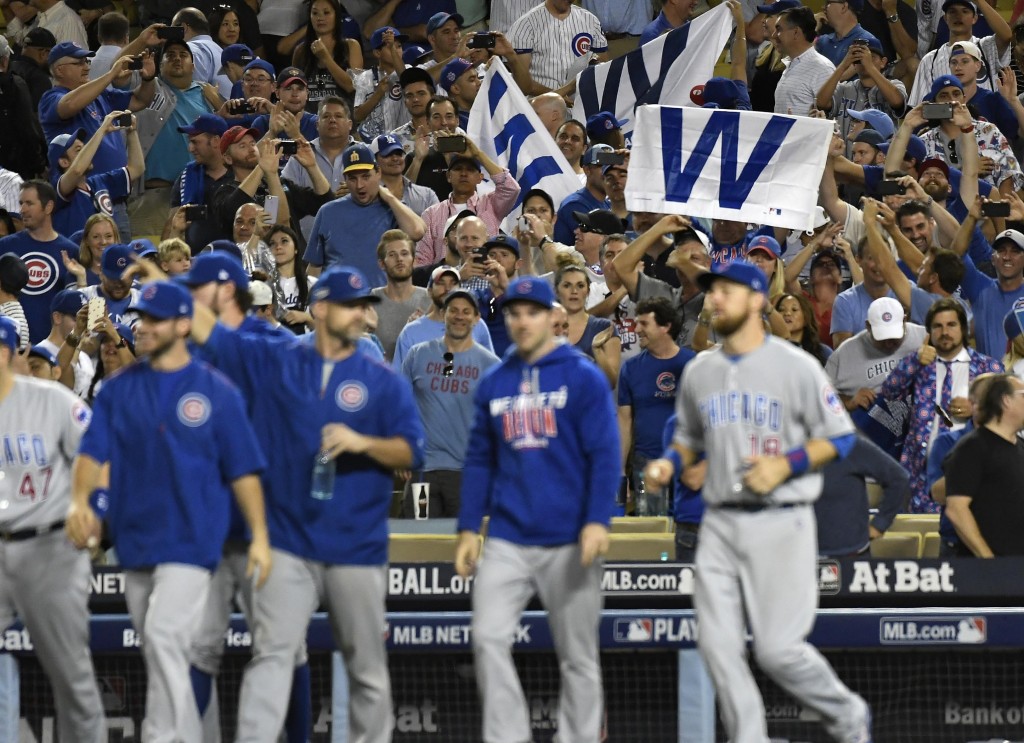 Oct 20, 2016; Los Angeles, CA, USA; Chicago Cubs fans hold up flags after the Chicago Cubs defeat the Los Angeles Dodgers 8-4 in game five of the 2016 NLCS playoff baseball series at Dodger Stadium. Mandatory Credit: Richard Mackson-USA TODAY Sports