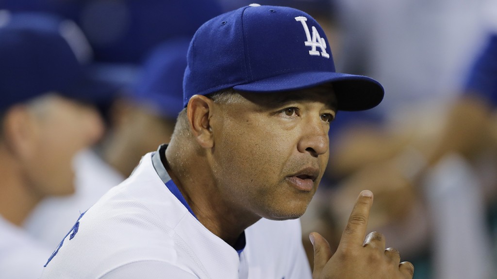 Los Angeles Dodgers manager Dave Roberts  watches from the dugout before the team's baseball game against the Colorado Rockies, Thursday, Sept. 22, 2016, in Los Angeles. (AP Photo/Jae C. Hong)