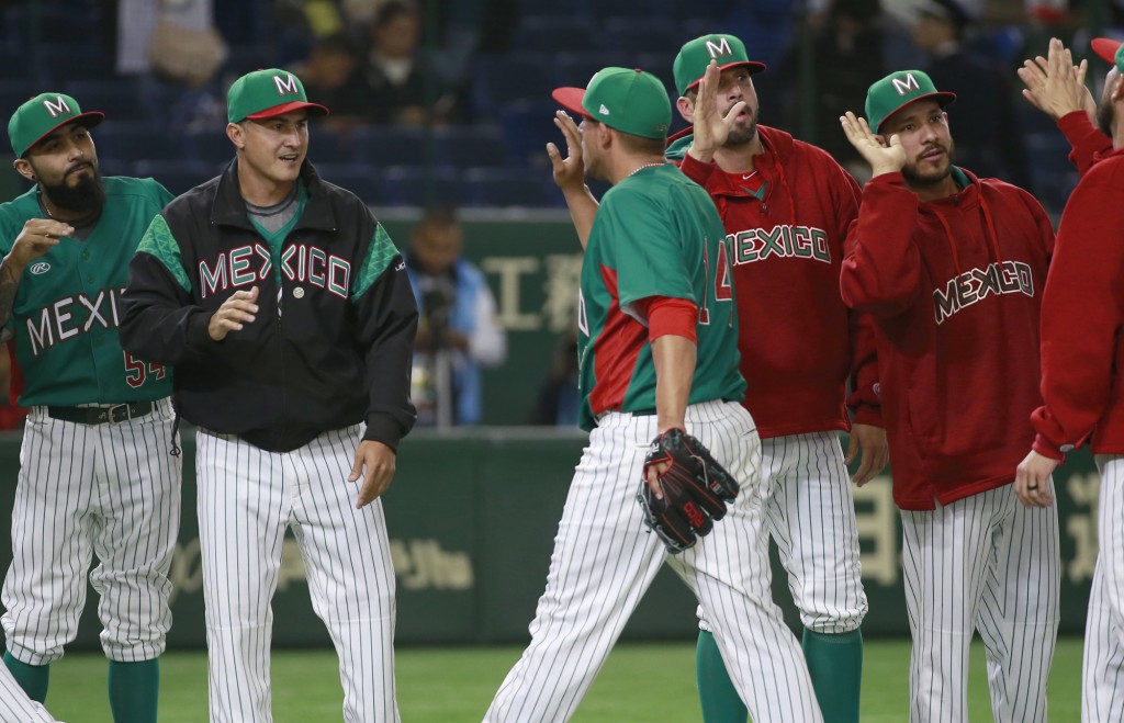 Mexico's manager Edgar Gonzalez, second from left, celebrates with teammates after their 7-3 win over Japan in their international exhibition series baseball game at Tokyo Dome in Tokyo Thursday, Nov. 10, 2016. (AP Photo/Shizuo Kambayashi)