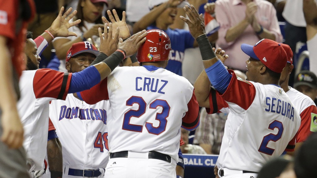Dominican Republic's Nelson Cruz (23) is congratulated after scoring on a single by Gregory Polanco during the second inning in a first-round game of the World Baseball Classic against Canada, Thursday, March 9, 2017, in Miami. (AP Photo/Lynne Sladky)
