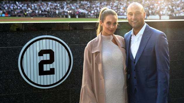 NEW YORK, NY - MAY 14:  Former New York Yankees captain Derek Jeter and his wife Hannah Jeter pose next to his number in Monument Park during the retirement cerremony of Jeter's jersey #2 at Yankee Stadium on May 14, 2017 in the Bronx borough of New York City.  (Photo by Elsa/Getty Images)
