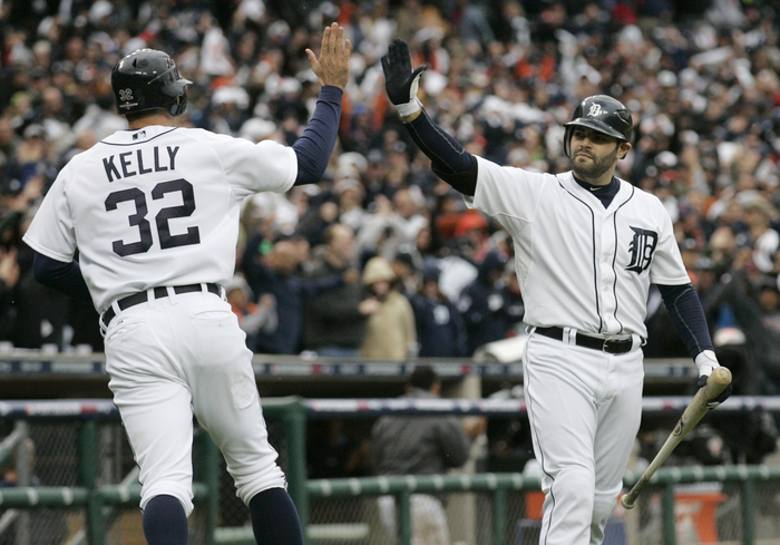Detroit Tigers Kelly is congratulated by teammate Avila after scoring on a wild pitch by Oakland Athletics pitcher Cook during the eighth inning of Game 2 in their MLB ALDS playoff baseball series in Detroit