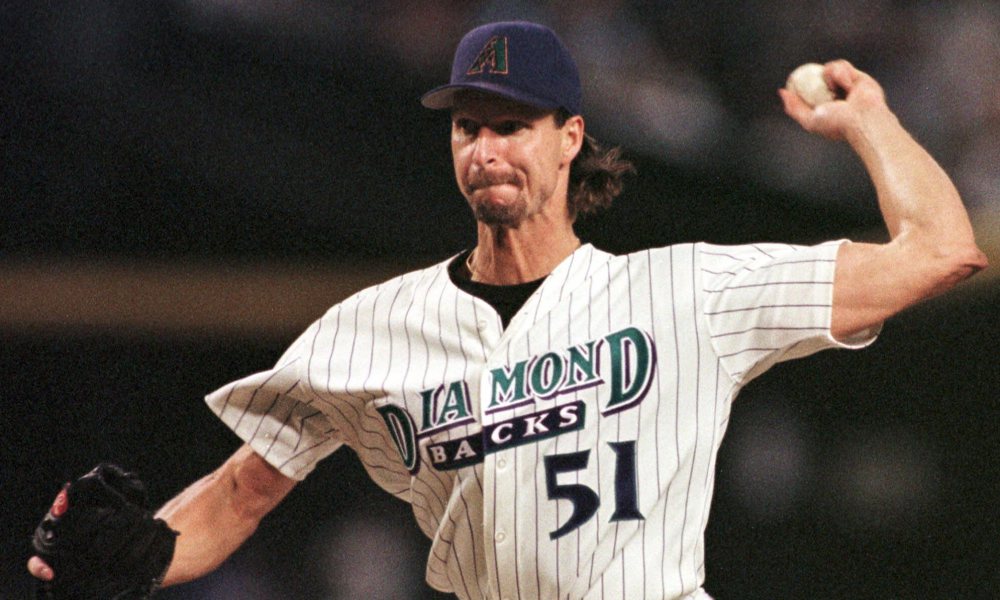 ADVANCE FOR WEEKEND of SEPT. 4-5--Arizona Diamondbacks starting pitcher Randy Johnson delivers in the second inning against the Montreal Expos Tuesday, Aug. 31, 1999, in Phoenix. Not much grows quickly in the desert, except a major league baseball contender. Baseball franchises, like the game itself, are supposed to develop slowly, paying their dues with years of mediocrity before earning the right to stand among the game's best.(AP Photo/Mike Fiala) ORG XMIT: NY153