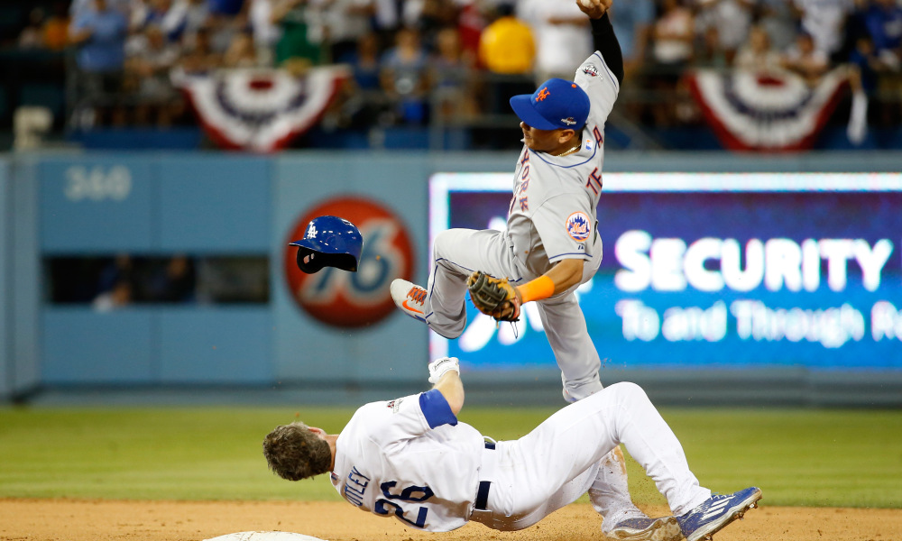 LOS ANGELES, CA - OCTOBER 10:  Ruben Tejada #11 of the New York Mets is hit by a slide by Chase Utley #26 of the Los Angeles Dodgers in the seventh inning in an attempt to turn a double play in game two of the National League Division Series at Dodger Stadium on October 10, 2015 in Los Angeles, California.  (Photo by Sean M. Haffey/Getty Images) ORG XMIT: 583924755 ORIG FILE ID: 492200898