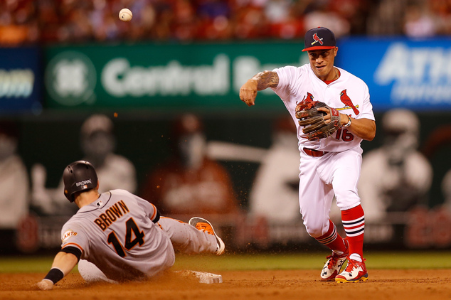 St. Louis Cardinals second baseman Kolten Wong, right, turns a double play over San Francisco Giants' Trevor Brown during the ninth inning of a baseball game Sunday, June 5, 2016 in St. Louis. (AP Photo/Scott Kane)