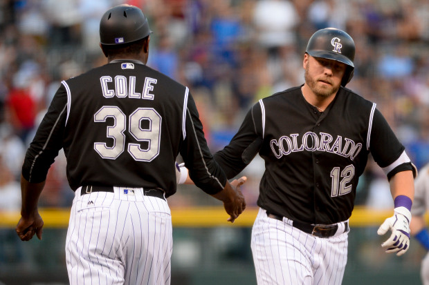 Colorado Rockies first basemen Mark Reynolds high fives third base coach Stu Cole after hitting a two-run home run during the first inning of the game against the Los Angeles Dodgers at Coors Field on August, 3, 2016. Michael Reaves, The Denver Post